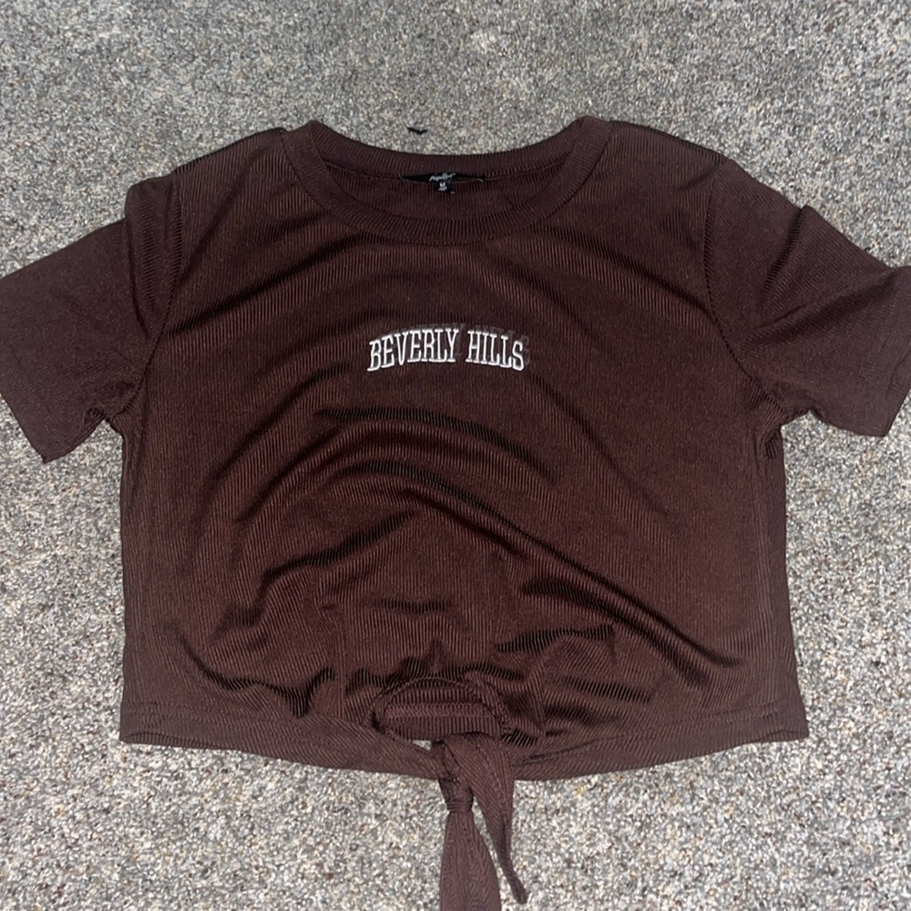 The brand is Papaya it is in a rich brown color with Beverly Hills on it